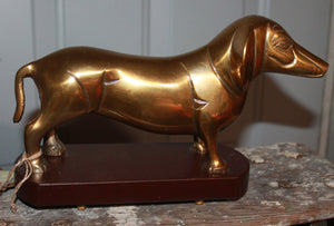 Brass dachshund with wooden stand